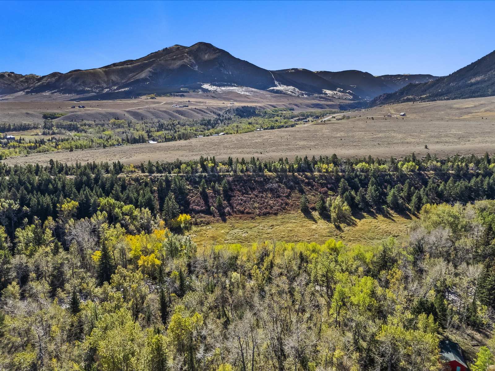 Drone view of a creek bottom in fall color near Red Lodge, Montana